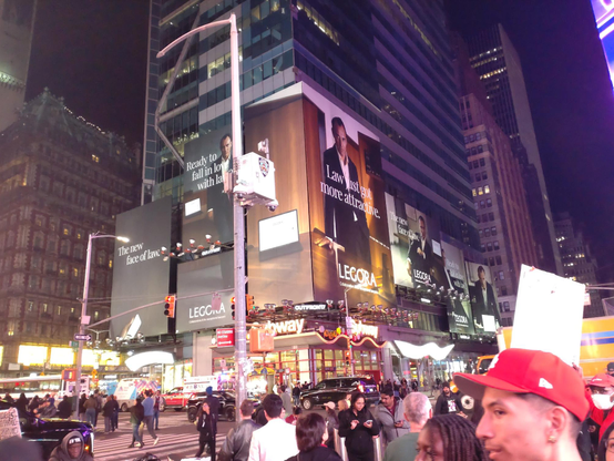 Billboards at times square for legal AI, featuring a clean cut white man, square jawed in a suit, in his fifties, James Bond vibes.