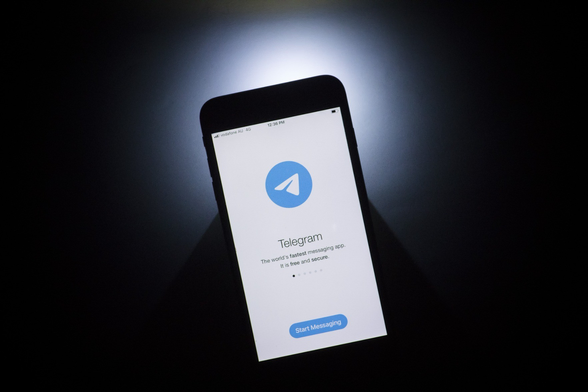Dark background. in the middle you can see a cell phone with the telegram app on the home screen. at the top the telegram symbol (blue circle with white sent sign) underneath it says " the worlds fastest messaging app. it's free and secure" at the very bottom of the cell phone screen blue start messaging button