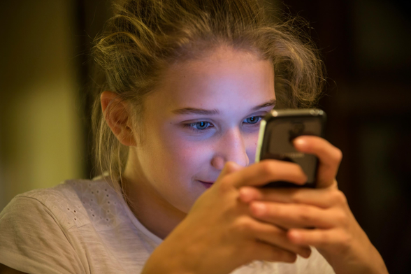 Young female viewing smart phone